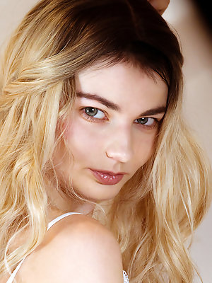 Francesca Rose seductively stares at you as she takes off her white lace top and panties on the soft white bed.